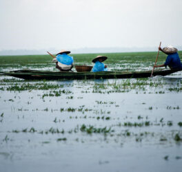 Men Riding Boat on Body of Water, Sunamganj, Sylhet Division, Bangladesh