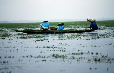 Men Riding Boat on Body of Water, Sunamganj, Sylhet Division, Bangladesh