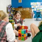 Three girls playing with blocks at PCYC Tamworth Outside Of School Hours care.