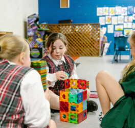Three girls playing with blocks at PCYC Tamworth Outside Of School Hours care.