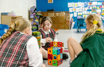 Three girls playing with blocks at PCYC Tamworth Outside Of School Hours care.