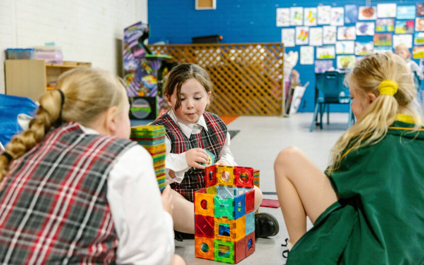 Three girls playing with blocks at PCYC Tamworth Outside Of School Hours care.