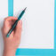 A hand holding a pen