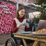 woman in wheelchair using computer