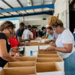 WFP volunteers packing relief supply boxes