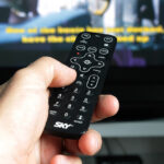 Person Hand Holding Remote Control