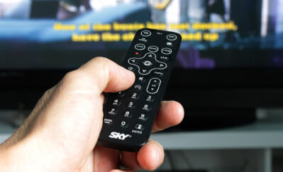 Person Hand Holding Remote Control