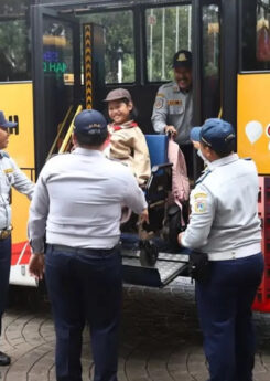 Girl in wheelchair geeting off the bus in the yard of Jakarta City Hall
