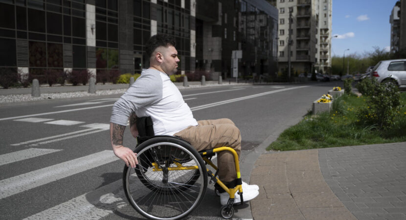 Man in wheelchair crossing the street