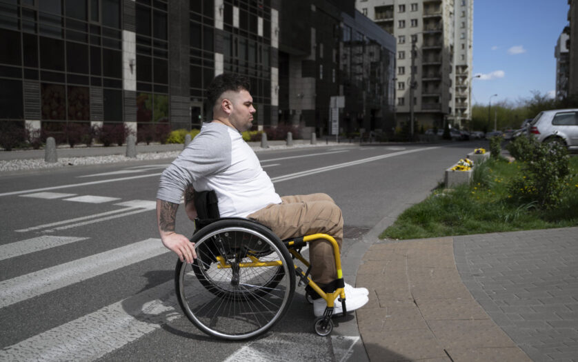 Man in wheelchair crossing the street