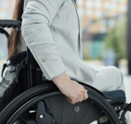 Close up of young woman in wheelchair entering building