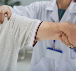 Senior man having shoulder and arm treatment in hospital