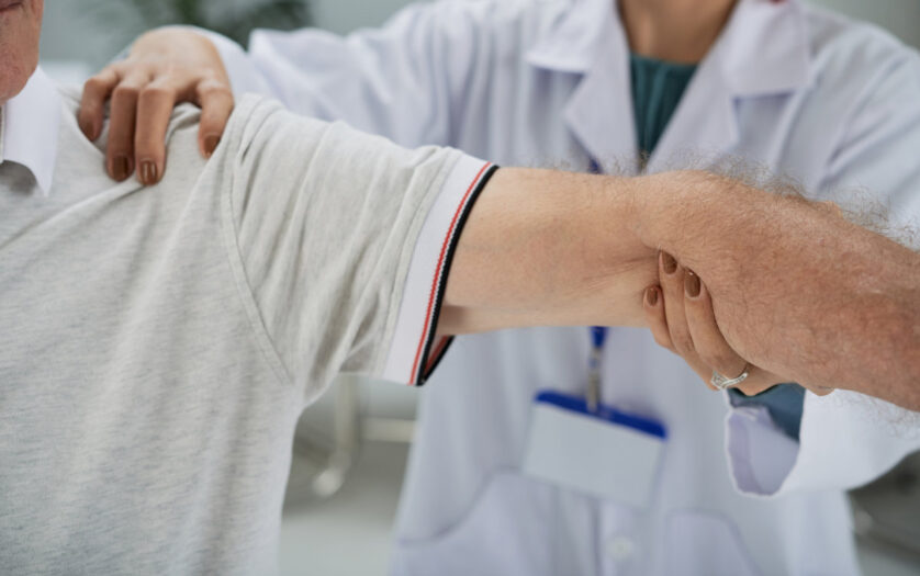 Senior man having shoulder and arm treatment in hospital