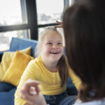 High angle smiley girl with down syndrome