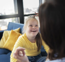 High angle smiley girl with down syndrome