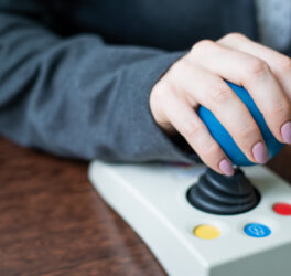 Close up of a woman hand on adaptive mouse using computer