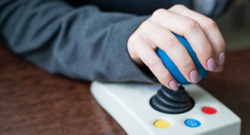 Close up of a woman hand on adaptive mouse using computer