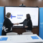 Representatives of UNICEF Syria and Finland shake hands.
