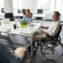 Man in wheelchair having meeting with colleagues in the office
