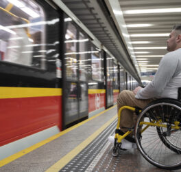 side view of a man in wheelchair at the station