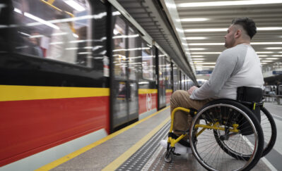 side view of a man in wheelchair at the station
