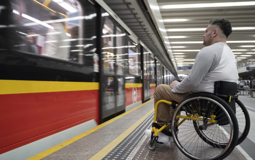 side view of a man in wheelchair at the station