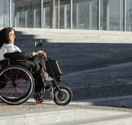 Side view of woman in a wheelchair on the street