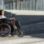 Side view of woman in a wheelchair on the street