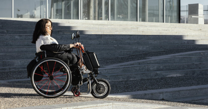 Side view of woman in a wheelchair on the street