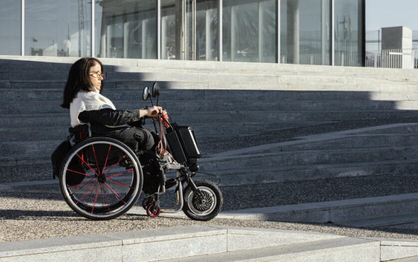 Side view of woman in a wheelchair on the street