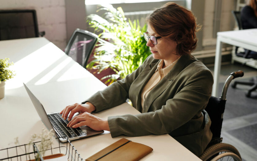 Woman in wheelchair working on laptop