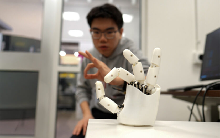 A researcher working with a robotic hand