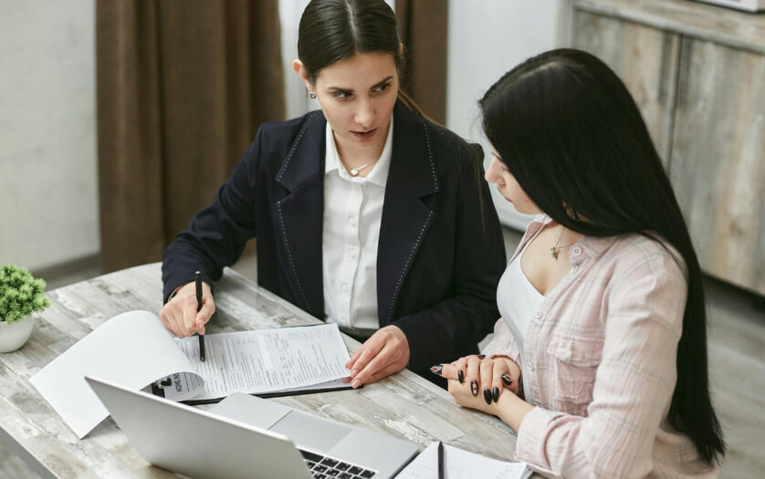 Women Discussing About Paperwork