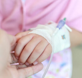 Mother holding child hand in hospital