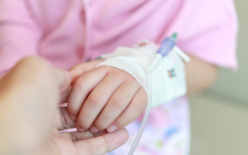 Mother holding child hand in hospital