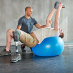 Person with disability, physiotherapist and help with kettlebell for stretching.