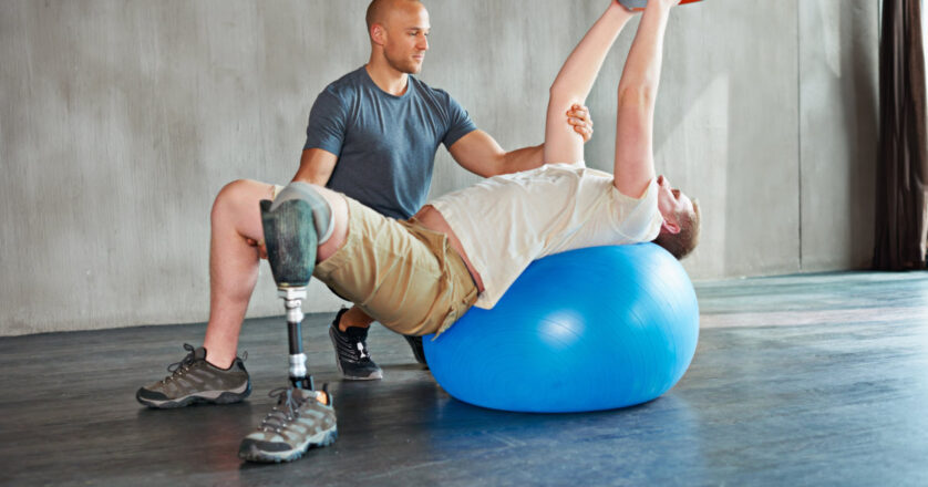 Person with disability, physiotherapist and help with kettlebell for stretching.