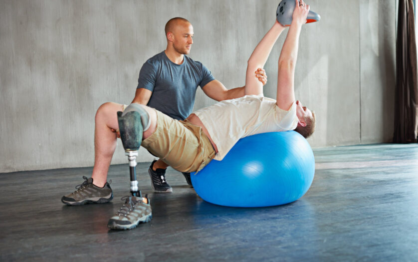 Person with disability, physiotherapist and help with kettlebell for stretching.