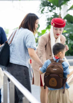 Emirates staff helping mother with kid with disability