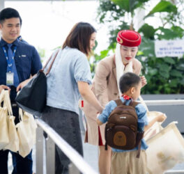 Emirates staff helping mother with kid with disability