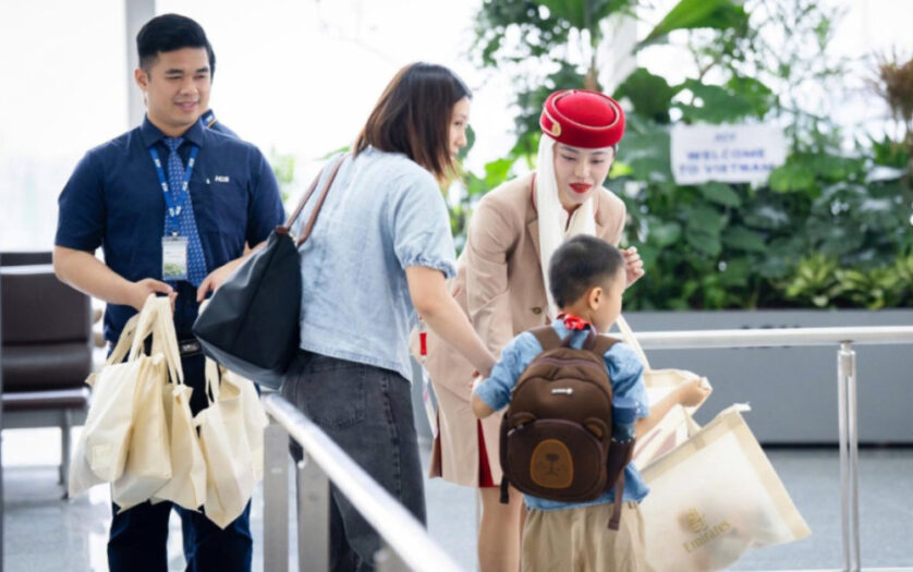 Emirates staff helping mother with kid with disability