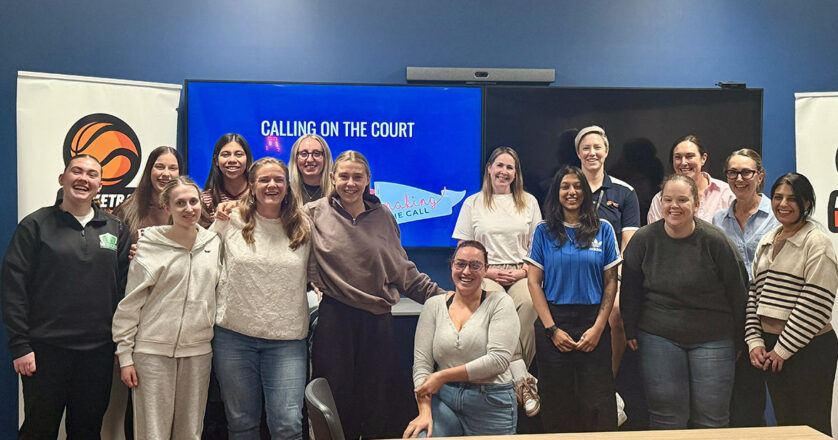 Women standing and sitting around a table after completing a workshop
