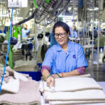 Woman Working in Textile Factory Smiling