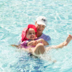 Milaya (left) participates in an adapted swim lesson with Tana Carson (right)