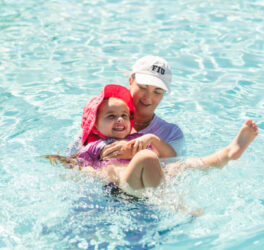Milaya (left) participates in an adapted swim lesson with Tana Carson (right)