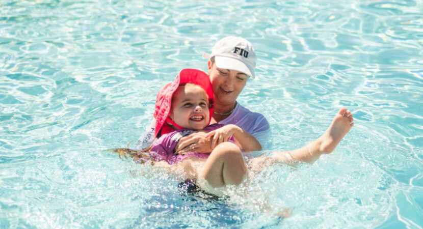 Milaya (left) participates in an adapted swim lesson with Tana Carson (right)