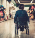 woman in wheelchair inside shopping mall
