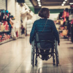 woman in wheelchair inside shopping mall