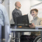 Woman in wheelchair with coworkers