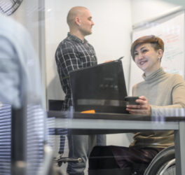 Woman in wheelchair with coworkers
